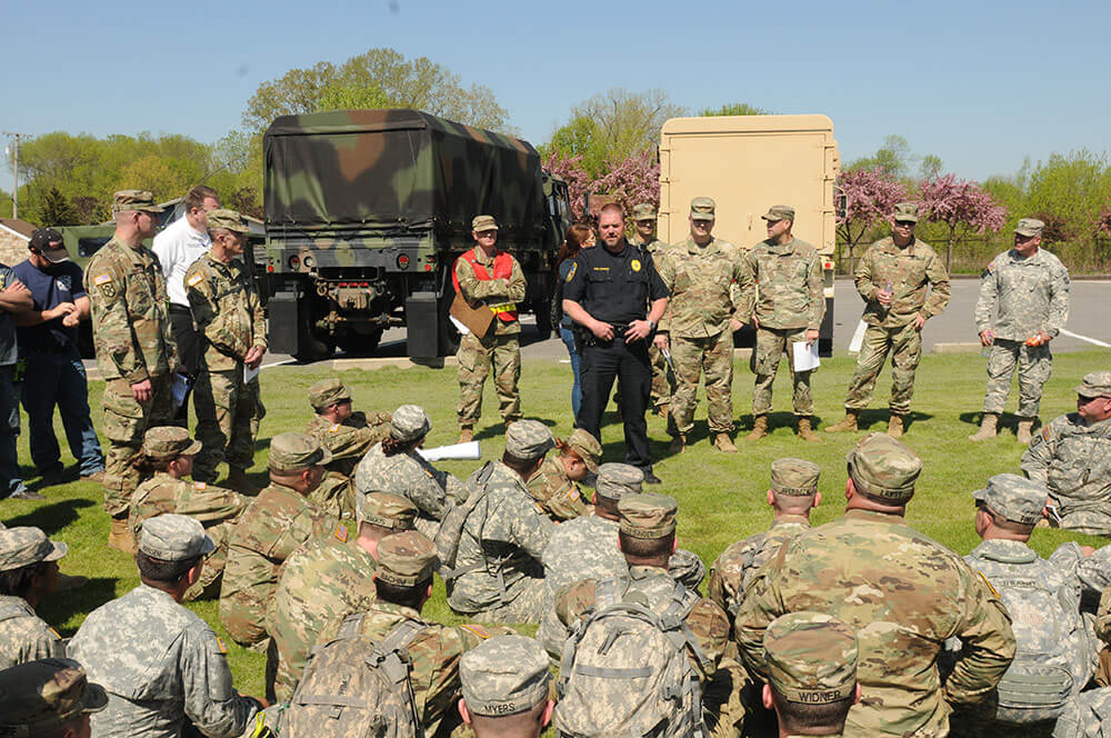 Omro, Wis., Police Chief Joe Schuster briefs Wisconsin National Guard Soldiers and other local and State first responders before they begin a canvassing operation in Omro as part of the Dark Sky training exercise. Wisconsin Army National Guard photo by SSG Matthew Ard