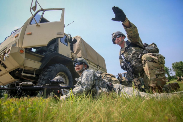 Army National Guard 1LT Robert Angelini (right) from New Jersey’s C Troop, 1st Squadron, 102nd Cavalry Regiment, points out enemy locations to fellow Soldiers during a training mission on Joint Base McGuire-Dix-Lakehurst, N.J. New Jersey National Guard photo by MSgt Matt Hecht