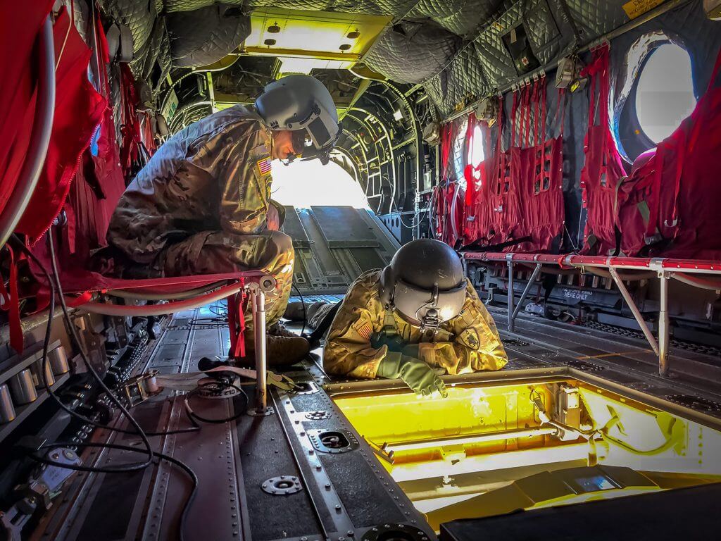 Soldiers from Nebraska Army National Guard’s Company B, 2-135th Aviation, practice sling load operations aboard a CH-47 Chinook helicopter at the Army Aviation Support Facility No. 2 in Grand Island, Neb. The exercise, done in preparation for the unit’s annual training, offered Soldiers the opportunity to access the underbelly of the helicopters and familiarize themselves with sling load operations to include attaching procedures. These procedures would be widely used if ever deployed to active combat. Nebraska Army National Guard photo by SPC Chris Sheen