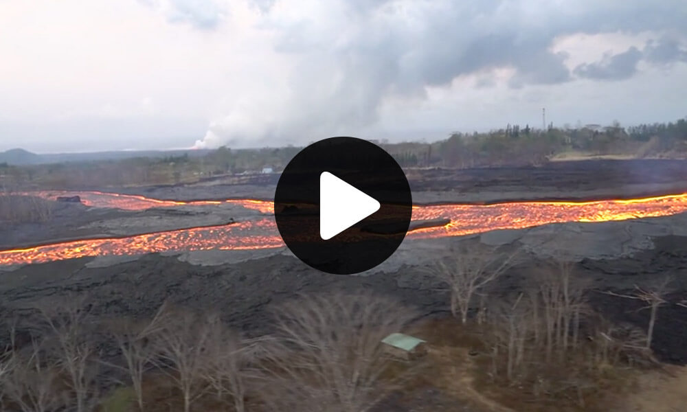 Aerial Survey of River of Lava as it Flows Down Valley in Hawaii thumbnail image