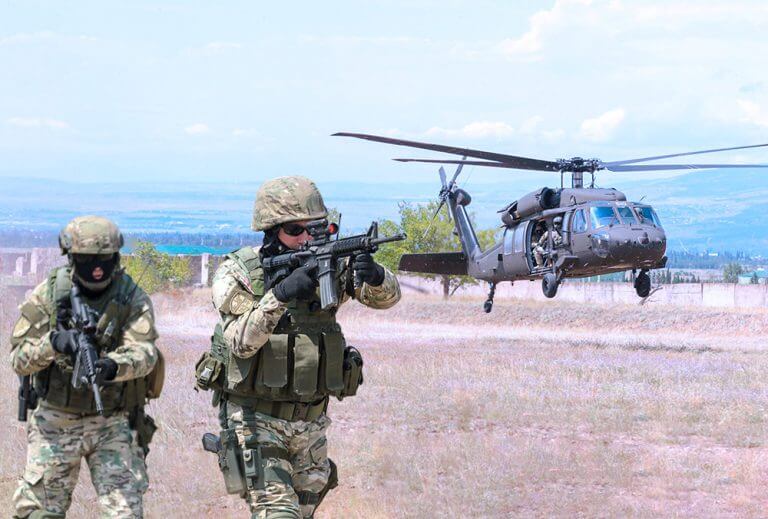 A UH-60 Black Hawk crew of the 1st Battalion, 171st Aviation Regiment, Georgia Army National Guard, lifts off after completing an aerial insertion of Special forces soldiers of the Georgian Armed Forces during an urban operations exercise at the Vaziani Training Area, Georgia, as part of Noble Partner 18. Georgia Army National Guard photo by SSG R. J. Lannom Jr.