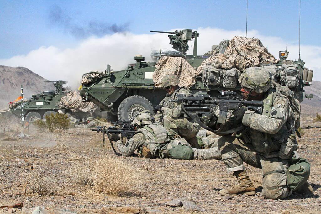 Infantrymen and Stryker crewmembers with Alpha Company, 2nd Battalion, 112th Infantry Regiment, 56th Stryker Brigade Combat Team, 28th Infantry Division, Pennsylvania Army National Guard, provide support by fire for Charlie Company Soldiers by engaging distant targets with M4 rifles, rifle-mounted M320 grenade launchers, M240 and M249 machine guns, and Stryker-mounted M2 .50 caliber machine guns during their training rotation at the National Training Center in Fort Irwin, Calif., August 2018. Pennsylvania Army National Guard photo by SGT Shane Smith