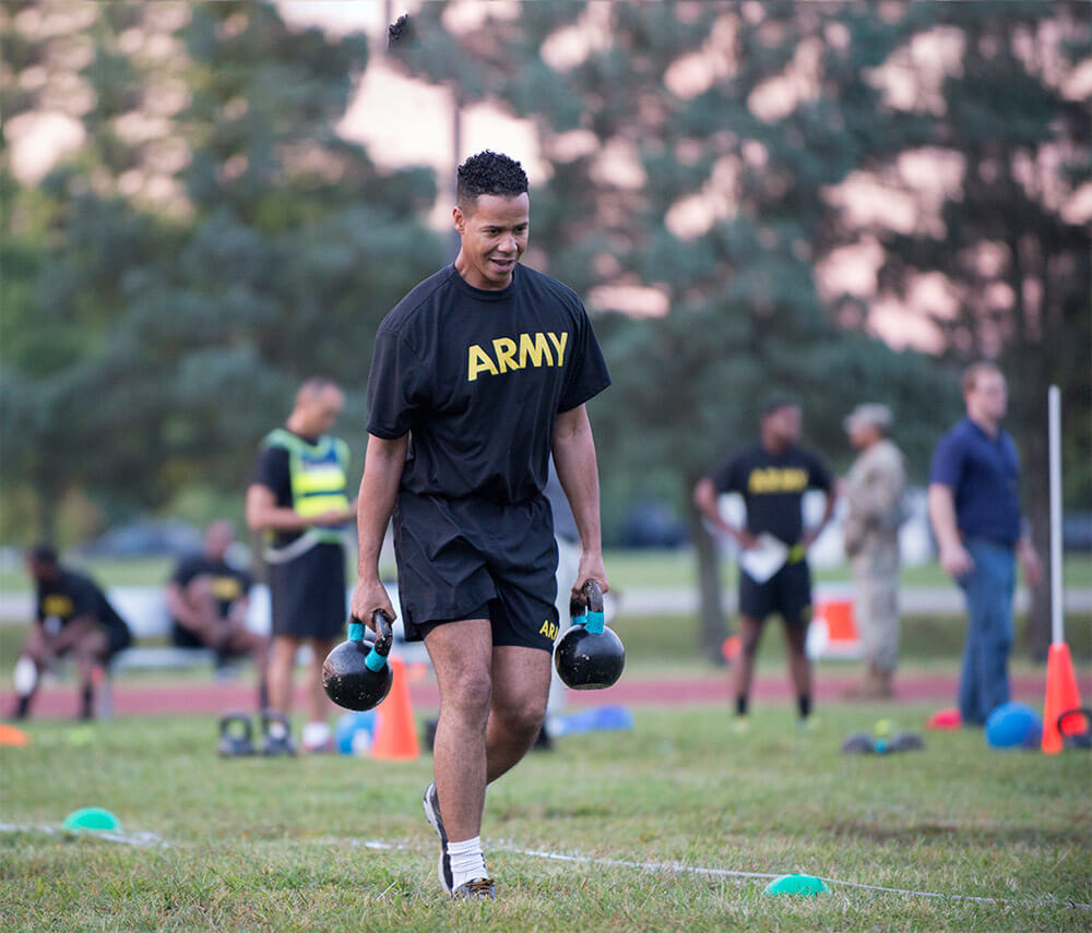 A Soldier carries two 40-pound kettlebell weights during a pilot for the new Army Combat Fitness Test. U.S. Army photo by Sean Kimmons