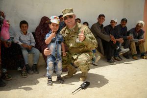 MAJ Che Eissinger, deputy commander of the Utah National Guard medical detachment, poses for a photo with a young Moroccan boy during the Humanitarian Civic Assistance component of Exercise African Lion 2018 in Bounaamane, Morocco, April 2018. Utah National Guard photo by TSgt Amber Monio