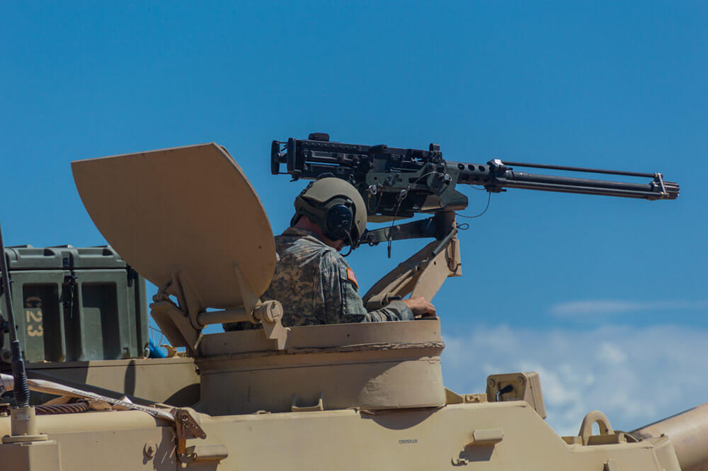 A Soldier of the 30th Armored Brigade Combat Team checks his orders before entering the firing line with his team in their M109 Howitzer as part of a live fire exercise during Operation Hickory Sting. National Guard Bureau photo by Luke Sohl