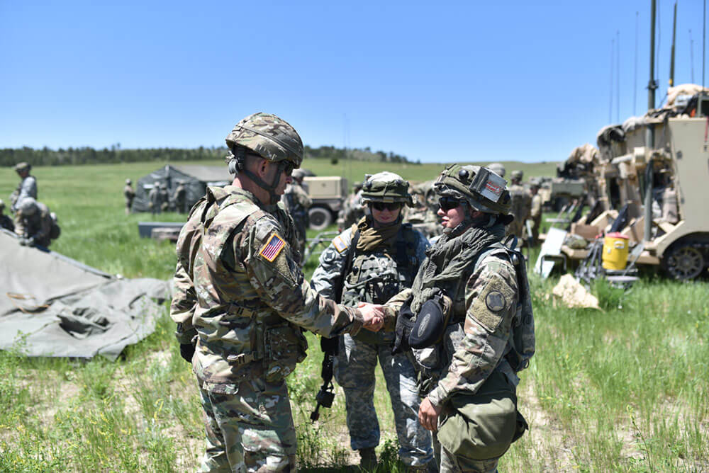 BG Troy D. Galloway, deputy commanding general, Army National Guard Combined Arms Center out of Fort Leavenworth, Kan., awards a coin to SPC Kaileigh Hamilton of the Headquarters and Headquarters Battery, 142nd Field Artillery Brigade, for exceptional work, going above expectations while participating in this Operation Western Strike 2018. Arkansas Army National Guard Photo by SSG Kelvin Green