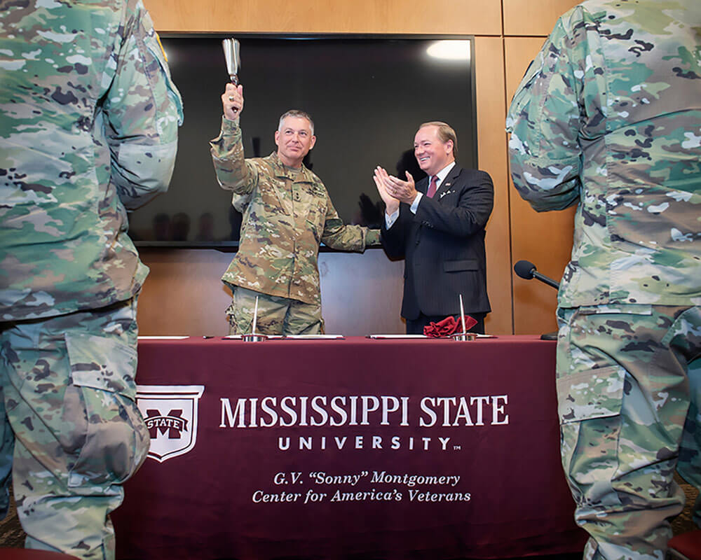 MG Janson D. Boyles, adjutant general of Mississippi, and Mississippi State University President Mark E. Keenum celebrate after signing a memorandum of agreement between MSU and the Mississippi National Guard to establish the Bulldog Free Tuition Program. Mississippi State University photo by Megan Bean