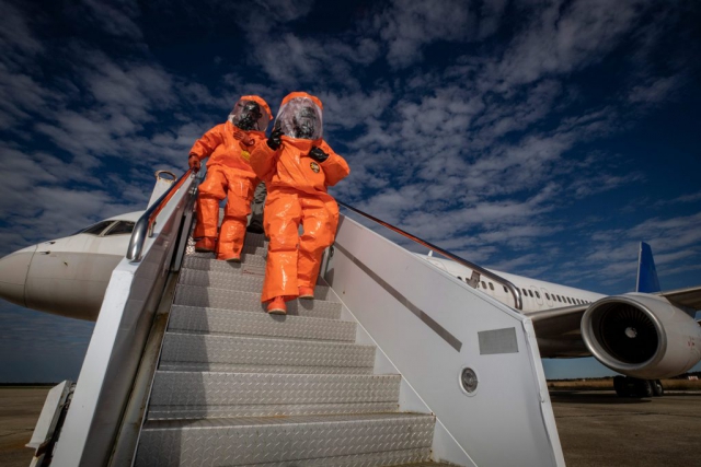 SGTs Mauricio Caceres and Cory Sweetman descend down air-stairs from an aircraft being used as part of a chemical, biological, radiological and nuclear defense exercise held at Atlantic City International Airport, N.J., in November of 2018. SGT Caceres and SGT Sweetman are with the 21st Weapons of Mass Destruction-Civil Support Team (21st WMD-CST), New Jersey National Guard. New Jersey National Guard photo by MSgt Matt Hecht