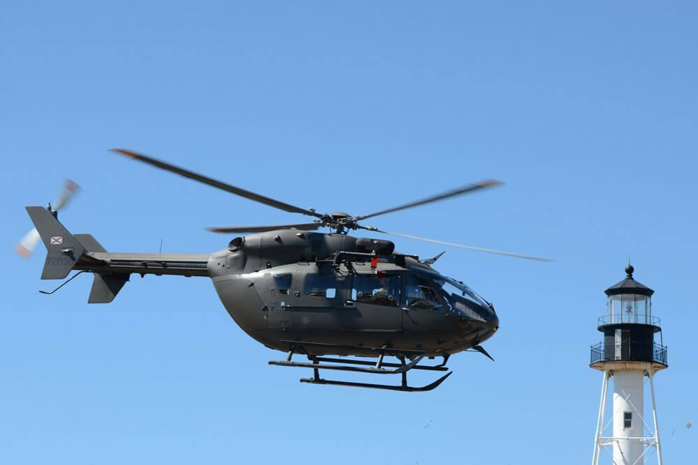 CPT Kevin King sits in the back of his UH-72 Lakota during down time while on duty at Annual Training.