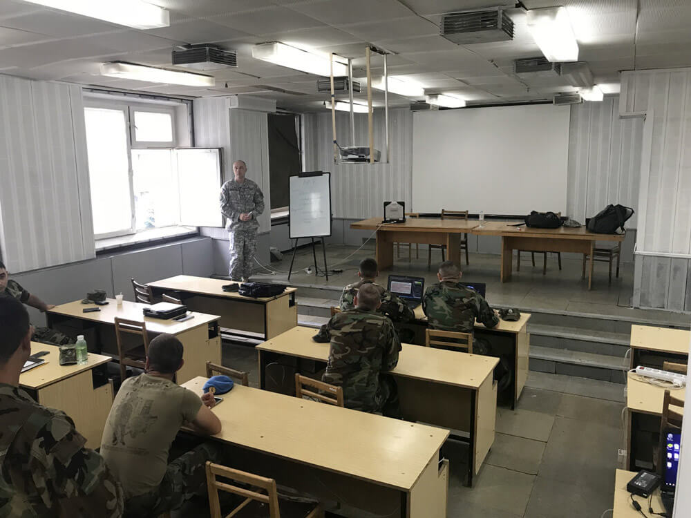 CW4 Donald Champion leads members of the Moldovan Armed Forces communications staff through a table-top training scenario as part of cyber defense training in Chisinau, Moldova, July 2018.