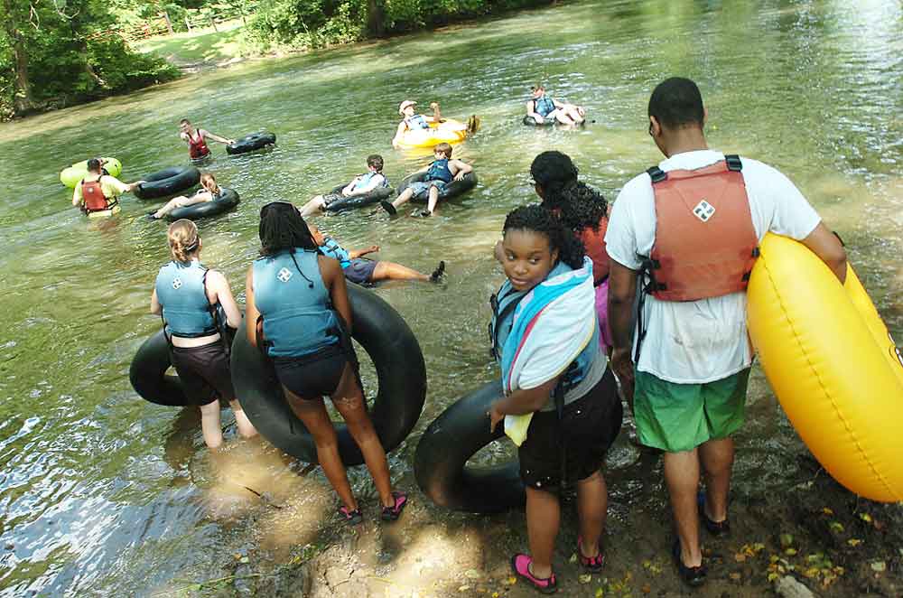Teen campers at the Virginia National Guard Teen Wilderness Adventure Camp prepare to go tubing down a river in New Castle, Va. Virginia Army National Guard photo by MSG A.J. Coyne