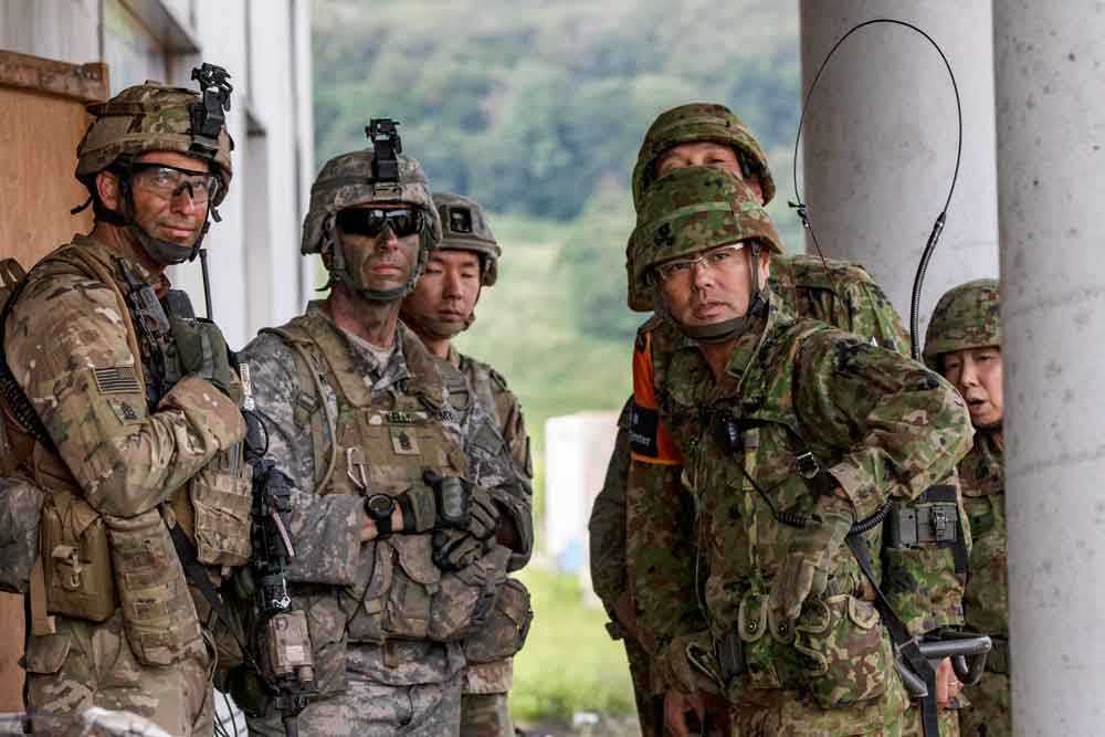 CSM Kelley Kelly of the 2nd Battalion, 151st Infantry Regiment, consults with his Japanese counterpart after a mock assault conducted as part of Exercise Orient Shield 2018, a bilateral, tactical field-training event held between U.S. Army Pacific Command and the Japan Ground Self-Defense Force.