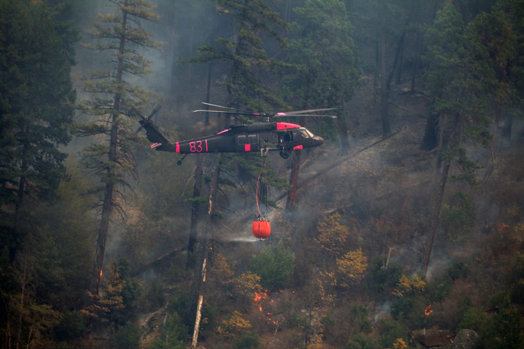 A U.S. Army UH-60M Black Hawk helicopter, co-piloted by 1LT Vincent Sherrill of the California Army National Guard’s 1st Assault Helicopter Battalion, 140th Aviation Regiment, flies through the Feather River Canyon in Butte County, Calif., carrying a water drop, Nov. 16, 2018, in support of the emergency response to the deadly Camp Fire. Also on board are pilot CW5 Rob Metoyer and crew chief SGT Gregory Fernandez. California National Guard photo by SrA Crystal Housman