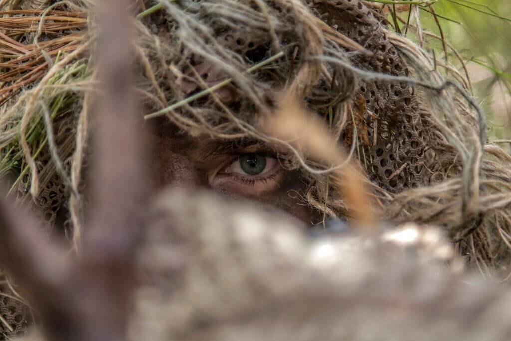 An Army National Guard Special Forces Soldier with the 20th Special Forces Group, Massachusetts Army National Guard, surveils a target during a reconnaissance and surveillance exercise on Joint Base Cape Cod, Mass., June 2018. The highly trained Soldiers serve part-time but maintain their high level of combat capabilities. Massachusetts National Guard photo by SPC Samuel D. Keenan