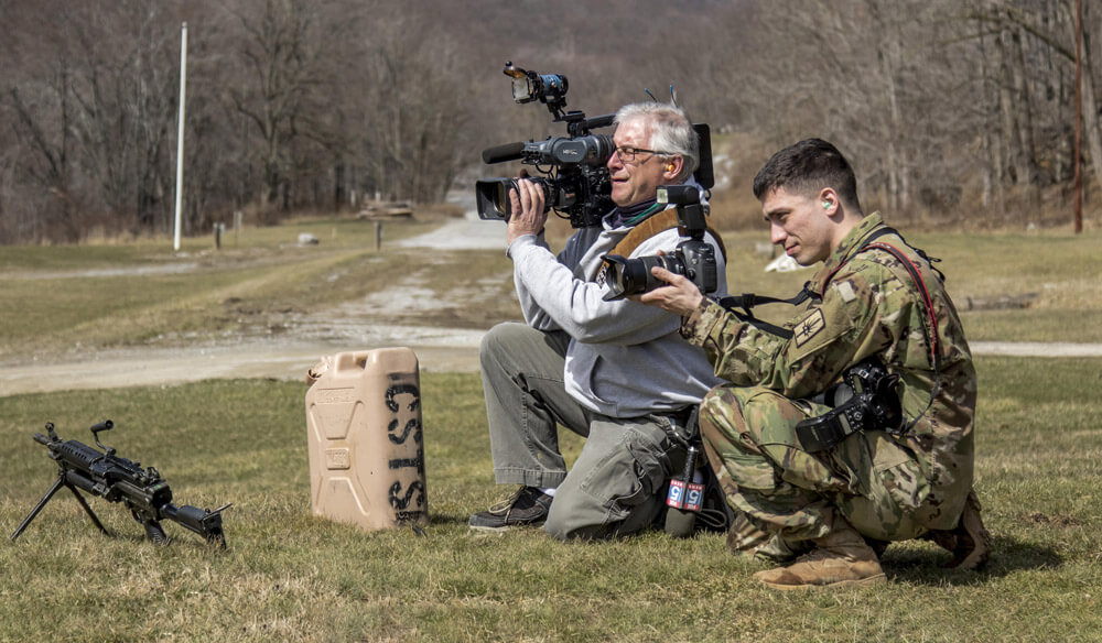 SGT Harley Jelis, a public affairs specialist attached to the 138th Public Affairs Detachment, 53rd Troop Command, New York Army National Guard, shoots photos and video next to a local news cameraman during the 2017 New York Army National Guard Best Warrior Competition at Camp Smith Training Site, N.Y. New York Army National Guard photo by SSG Michael Davis