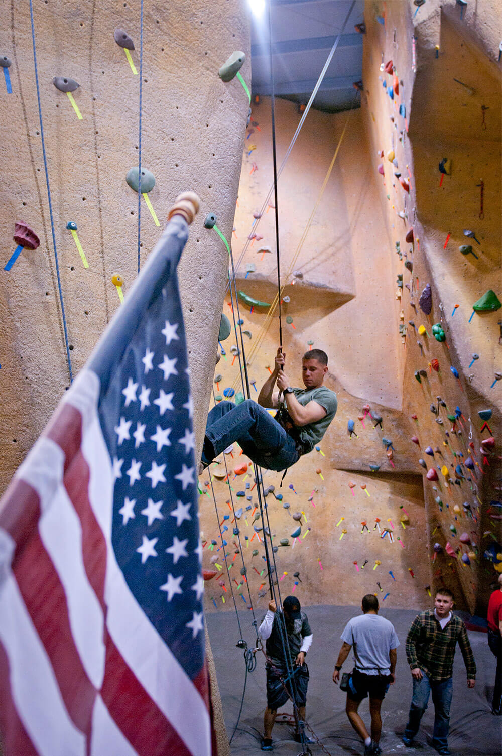 1LT Nick Westendorf, an operations officer with Headquarters and Headquarters Company, 8th Engineer Battalion, belays down after climbing a wall in the Boulders Sport Climbing Center in Harker Heights, Texas, as part of a Warrior Adventure Quest event.