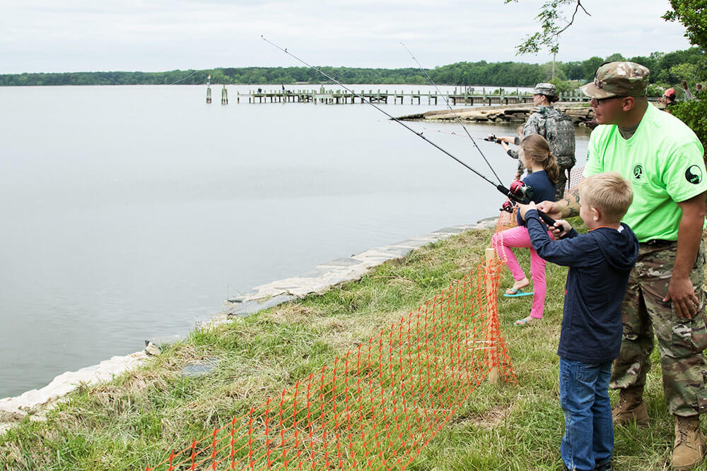 Soldiers of the 29th Combat Aviation Brigade help children of the unit’s deployed Soldiers during a kids’ fishing tournament hosted by the 29th and the Army Aviation Association of America Mid Atlantic Chapter, in partnership with the local Family Readiness Support Center, at CAPA Field, Aberdeen Proving Ground, Edgewood Area, Md., May 2017. Maryland Army National Guard photo by SGT Nancy Spicer
