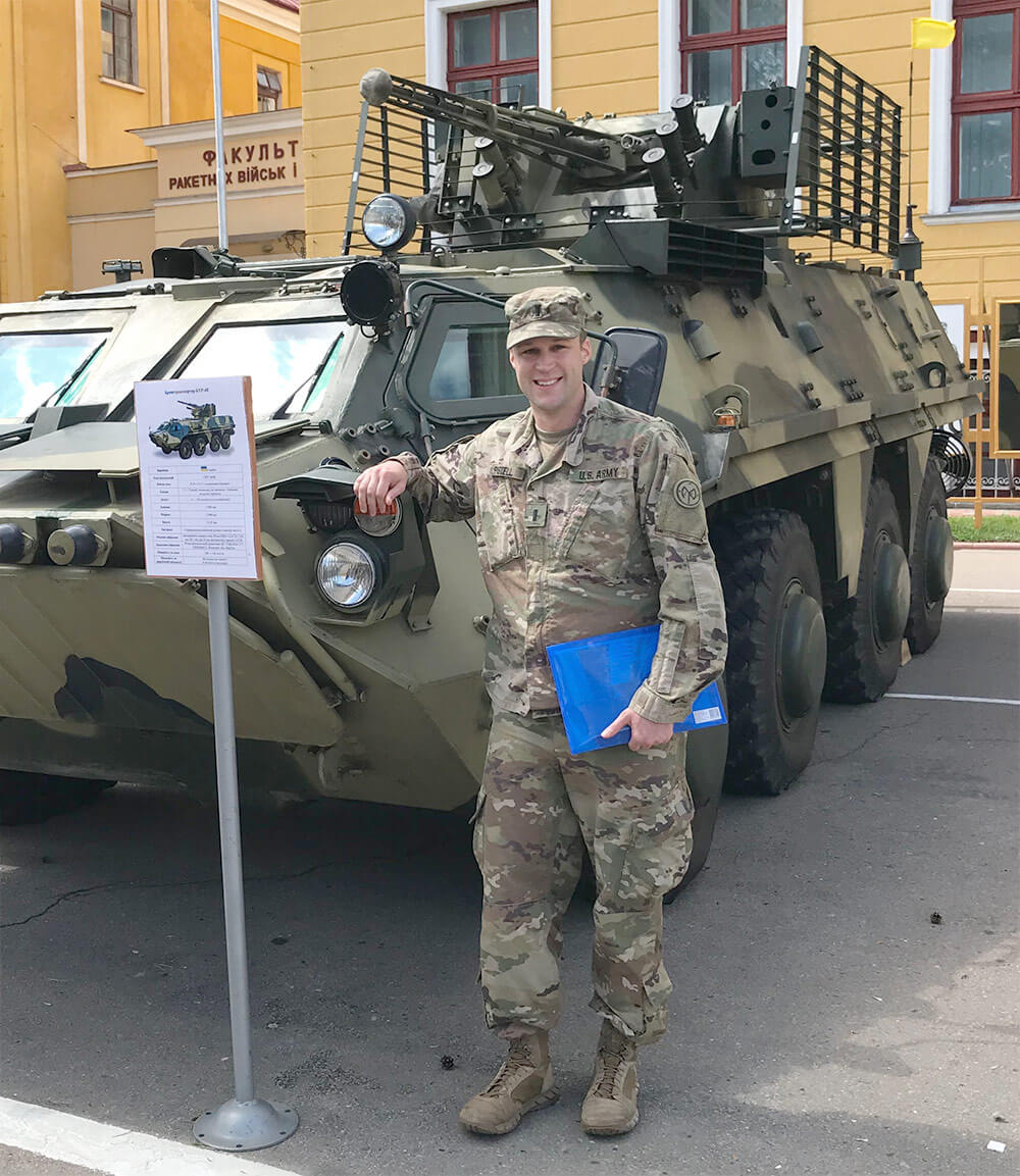 New York Army National Guard’s 1LT James Pistell, executive officer of Headquarters and Headquarters Troop 2nd Battalion, 101st Cavalry, poses by a Ukrainian personnel carrier at the Yavoriv Combat Training Center near Livov, Ukraine. Photo courtesy 1LT James Pistell