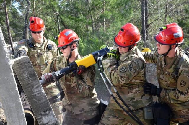 Soldiers with the Kentucky Chemical, Biological, Radiological and Nuclear Enhanced Response Force Package (CERFP)’s breech and break team use a hammer drill to extract a simulated victim from a rubble pile during an exercise evaluation at Camp Blanding, Fla., January 2019. The CERFP was tasked with responding to a 10-kiloton nuclear explosion, establishing a support zone, searching the hot zone for victims, extracting the victims from the hot zone, decontaminating the victims and providing medical assistance. Kentucky Army National Guard photo by SGT Taylor Tribble