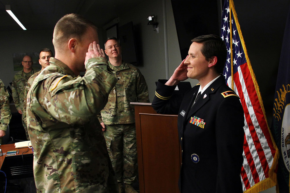 Then newly appointed WO1 Natalie Wamsley salutes her husband, CW2 Ronald Wamsley during a commissioning ceremony in Frankfort, Ky., March 2019. Kentucky Army National Guard photo by SFC Scott Raymond