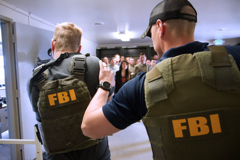 Federal Bureau of Investigation team members demonstrate an execution of a search warrant in a potentially hostile environment during the exercise portion of Cyber Shield 19 at Camp Atterbury, Ind. Illinois Army National Guard photo by SPC William Phelps