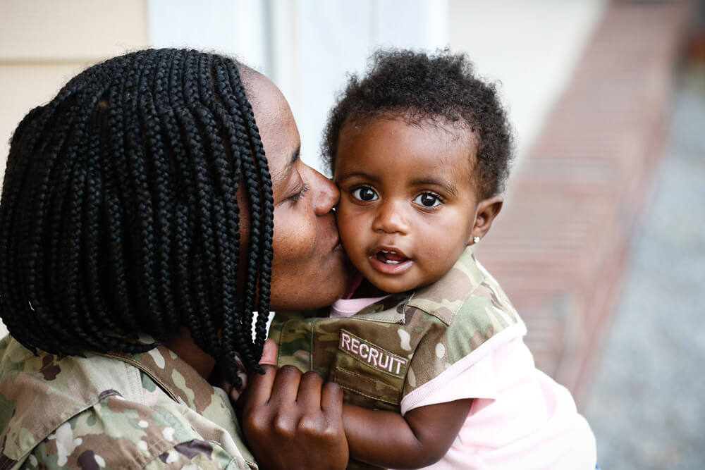 SPC ShaTyra Reed with daughter Amore Cox. U.S. Army photo by PFC Hubert D. Delany III