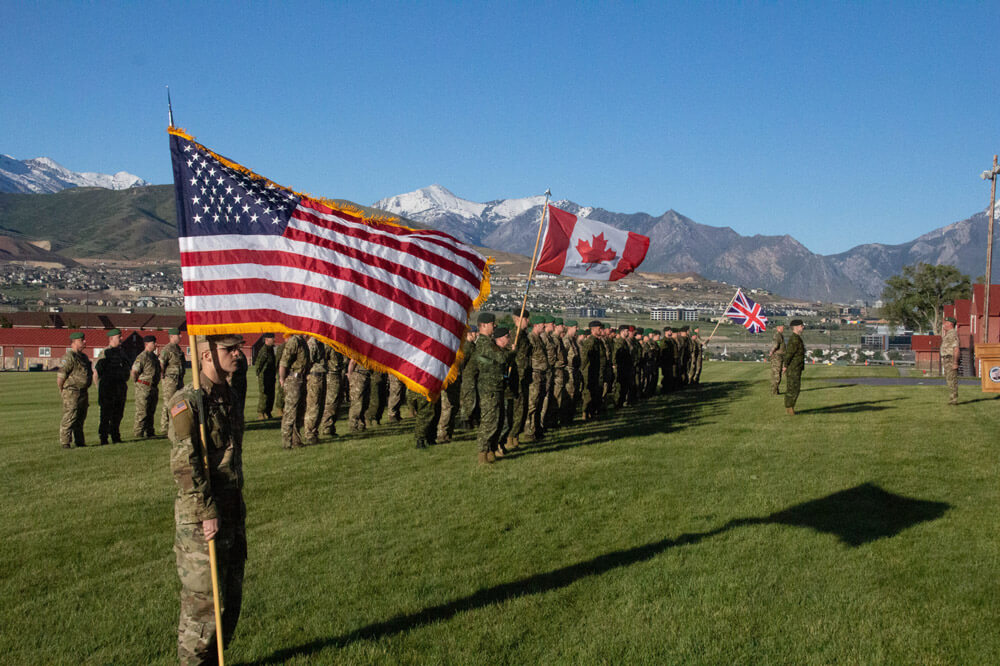Soldiers from the United States, United Kingdom and Canada stand in formation as part of a ceremony during Panther Strike, June 2019 at Camp Williams, Utah. Utah Army National Guard photo by SGT Nathan Baker