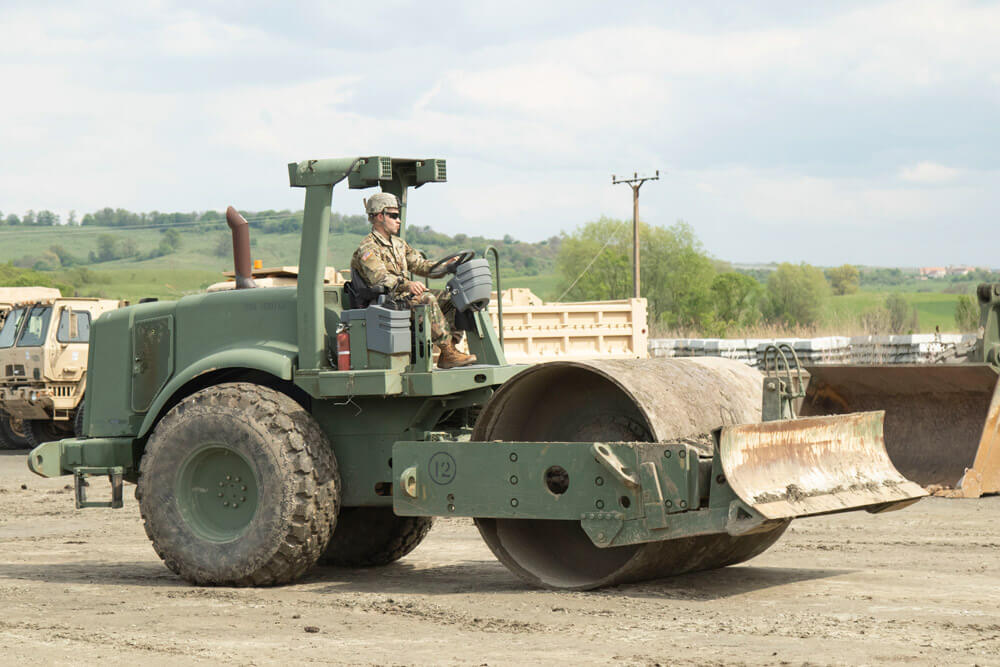 Alaska Army National Guard’s PVT Julien Harris of the 207th Engineer Utility Detachment, moves a roller in the motorpool during exercise Resolute Castle 19 at the Land Forces Combat Training Center Getica, Cincu, Romania, May 2019. Alaska Army National Guard photo by PVT Grace Nechanicky