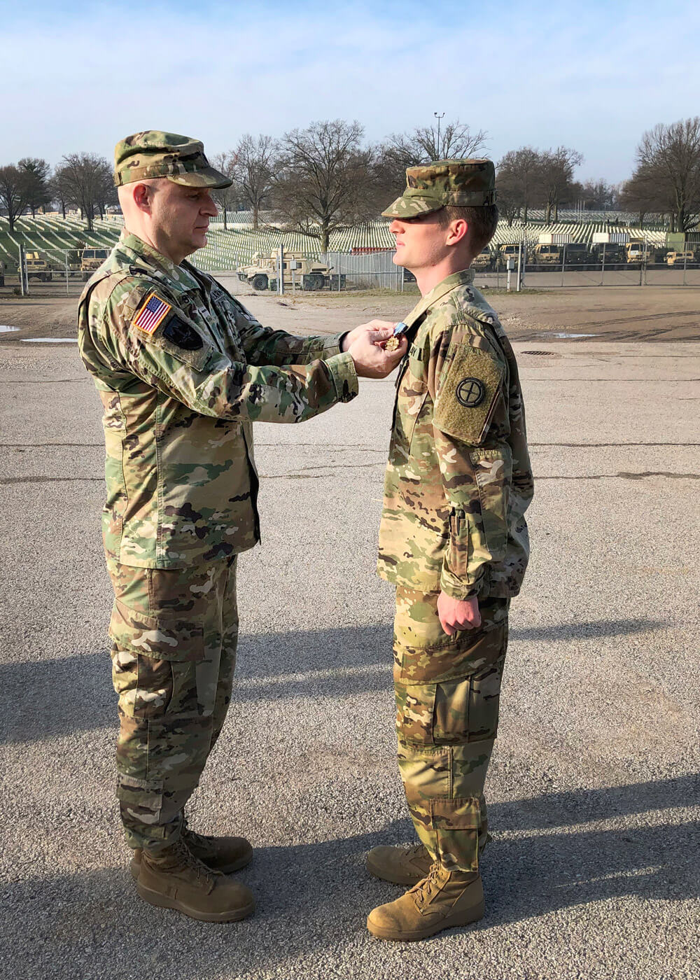 LTC Joshua Stewart (left), a division chief with the U.S. Transportation Command, presents Missouri Army National Guard Solider SPC Taylen Winchell with the Joint Service Achievement Medal at Jefferson Barracks, near St. Louis, April 2019. Missouri Army National Guard photo by MAJ Chris Morales