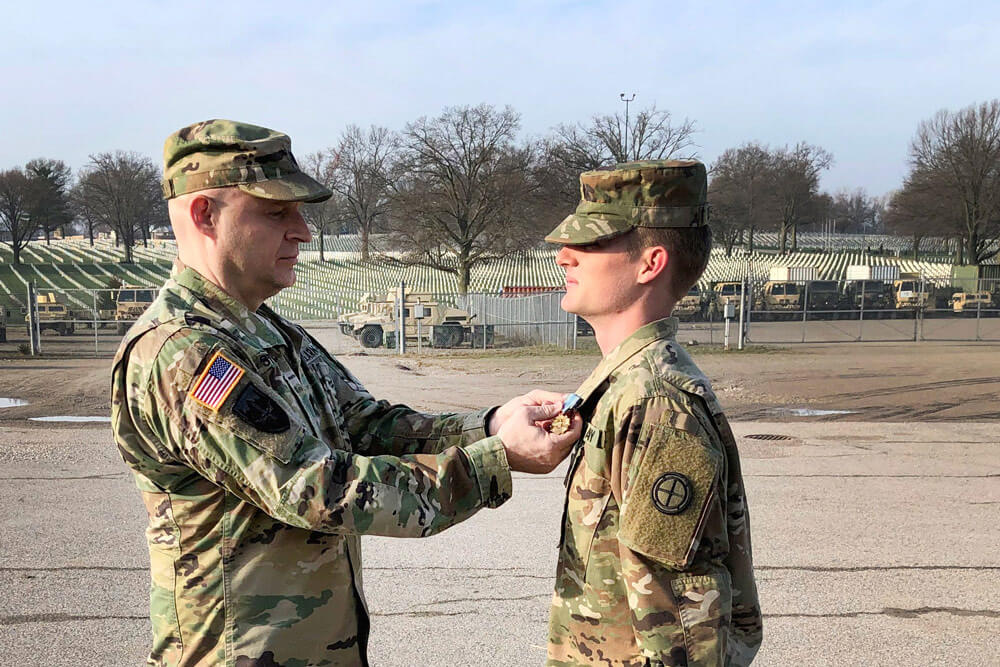 LTC Joshua Stewart (left), a division chief with the U.S. Transportation Command, presents Missouri Army National Guard Solider SPC Taylen Winchell with the Joint Service Achievement Medal at Jefferson Barracks, near St. Louis, April 2019. Missouri Army National Guard photo by MAJ Chris Morales